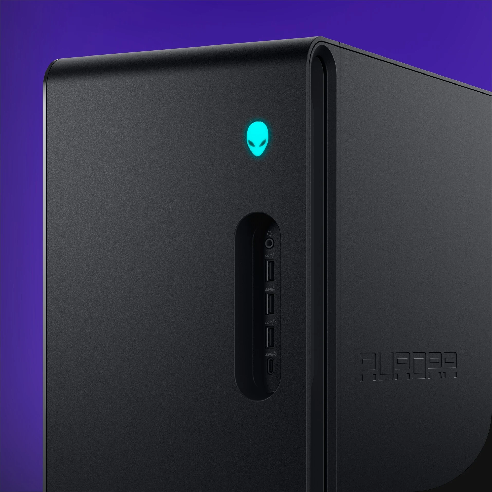 The Alienware Aurora Gaming Desktop is photographed from a rear angle, showcasing its black finish and illuminated alien logo.