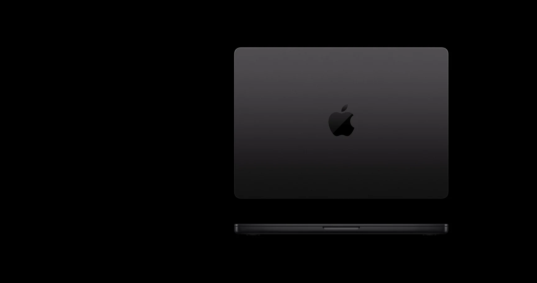 A black MacBook Pro with the Apple logo centered on its back, photographed from behind against a dark background.