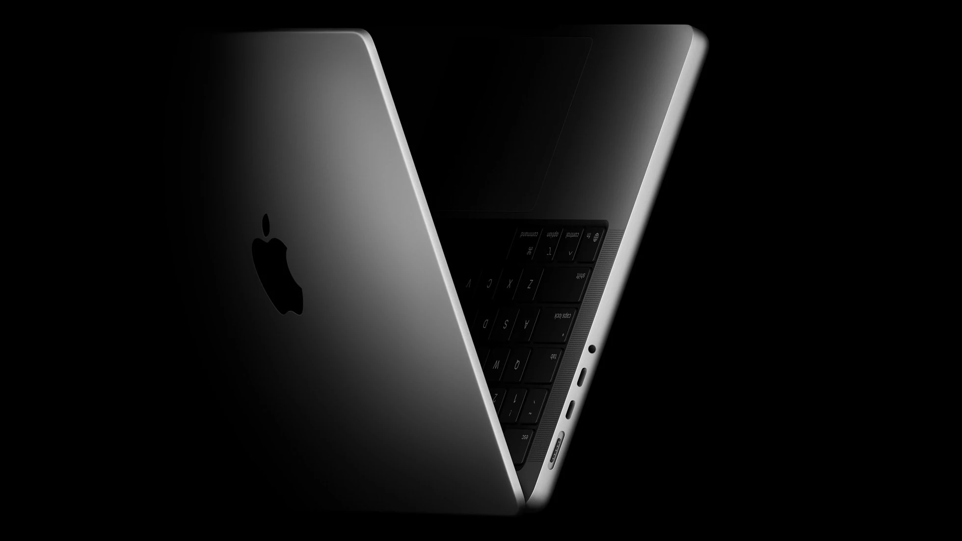 Space Black MacBook Pro with a three-quarter angle showing the back and part of the keyboard.