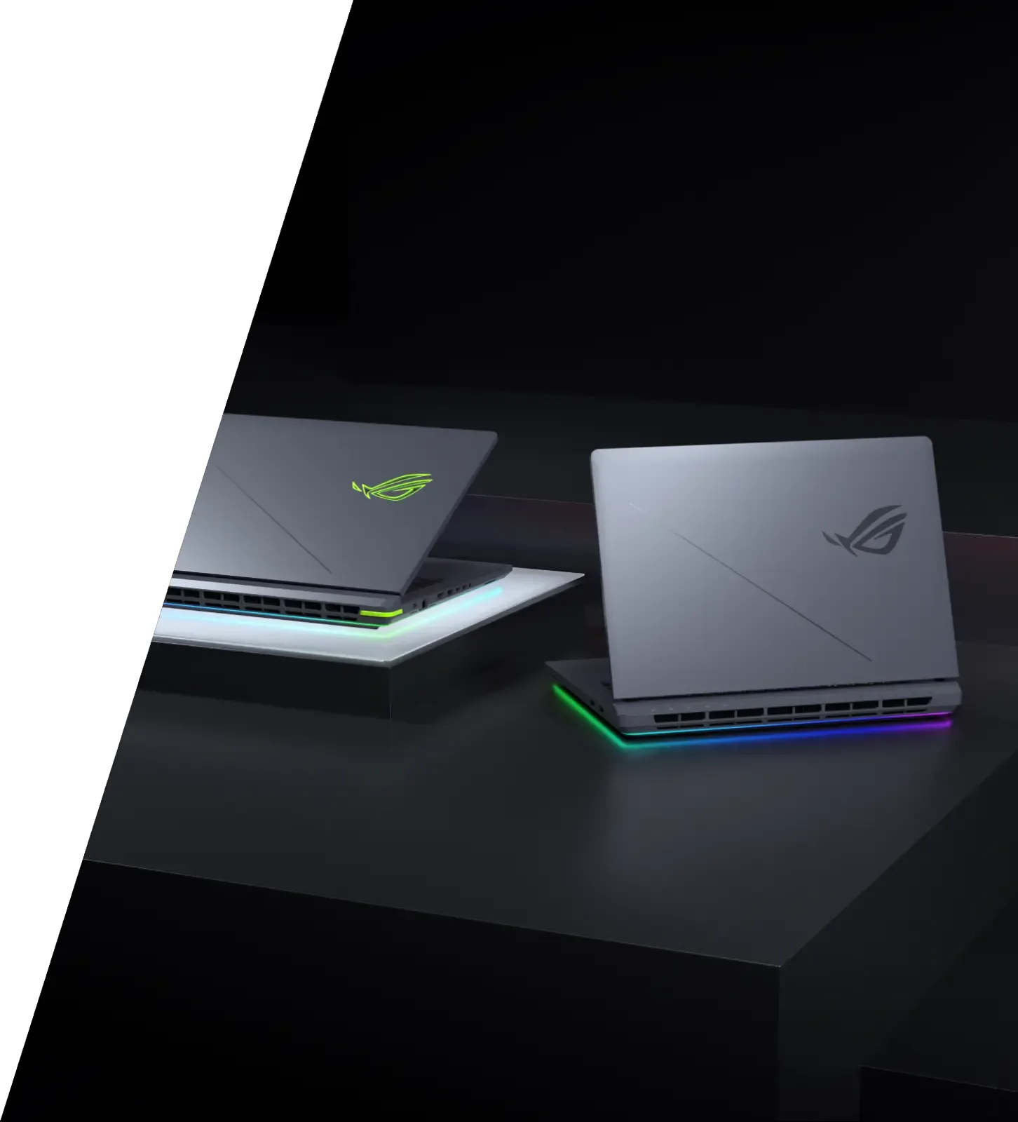 Two ASUS ROG Strix G16 laptops are displayed side by side on a dark surface, with their back panels facing the camera and illuminated edges.