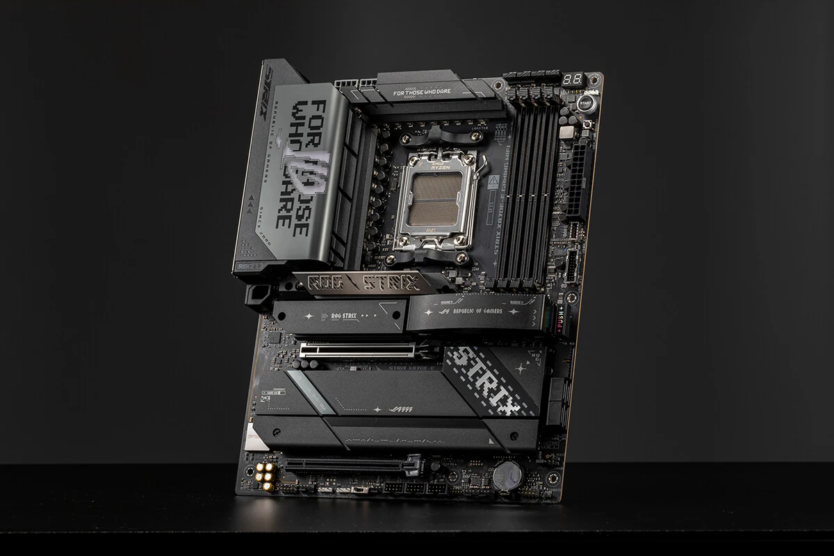 A black motherboard with 'ROG STRIX' branding prominently displayed on the front and top, positioned at a three-quarter angle against a dark background.