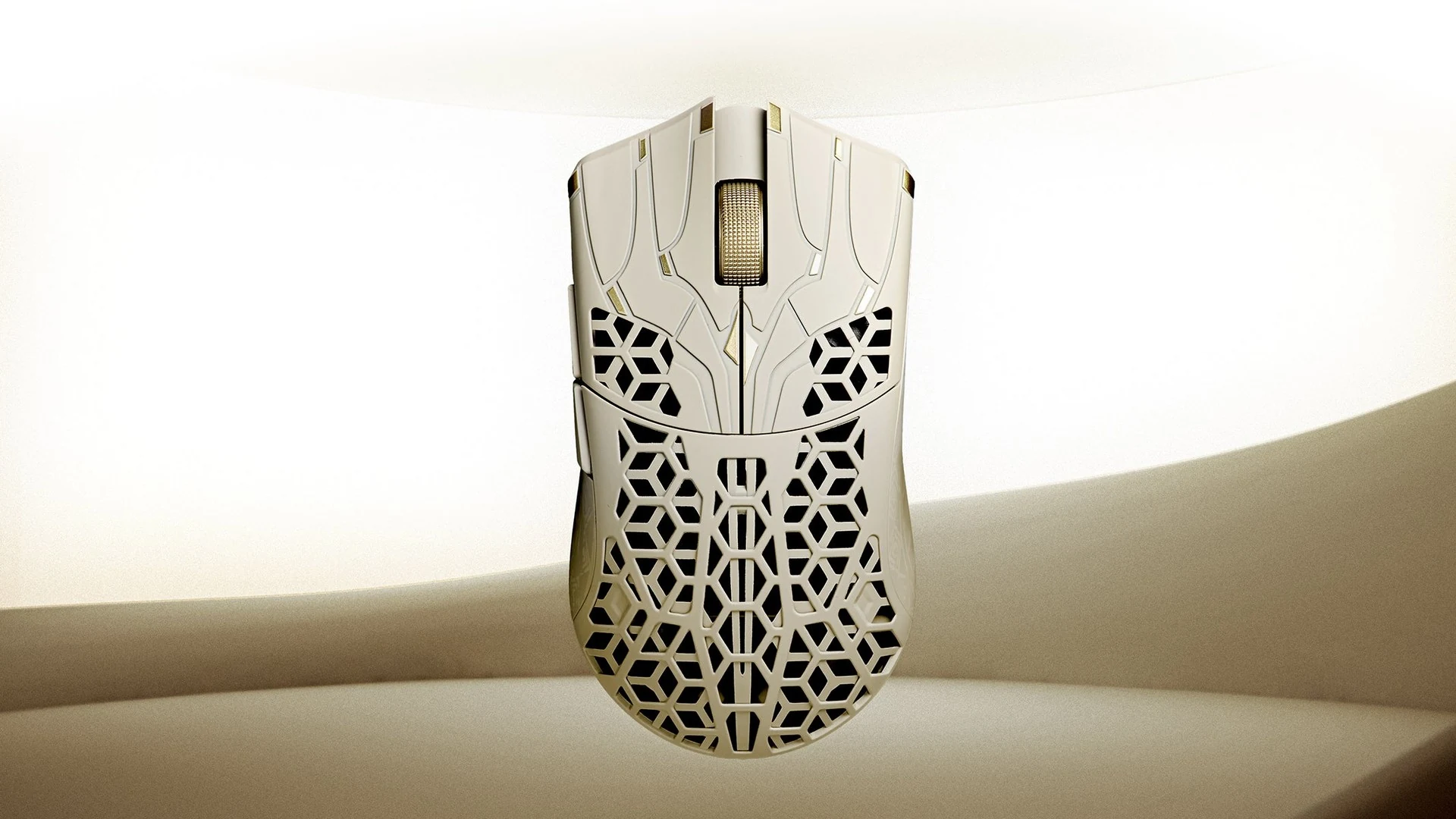The image shows a white gaming mouse with intricate geometric patterns on its body, photographed from the front.