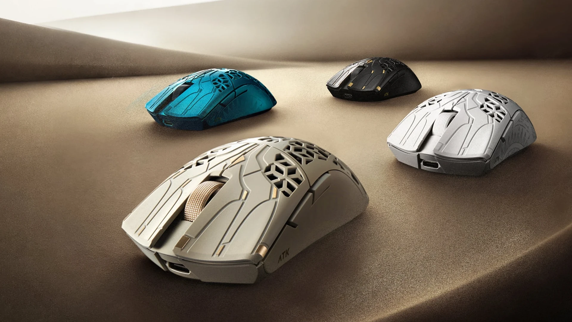 The image shows three gaming mice in different colors (blue, black, and silver) placed on a textured surface.