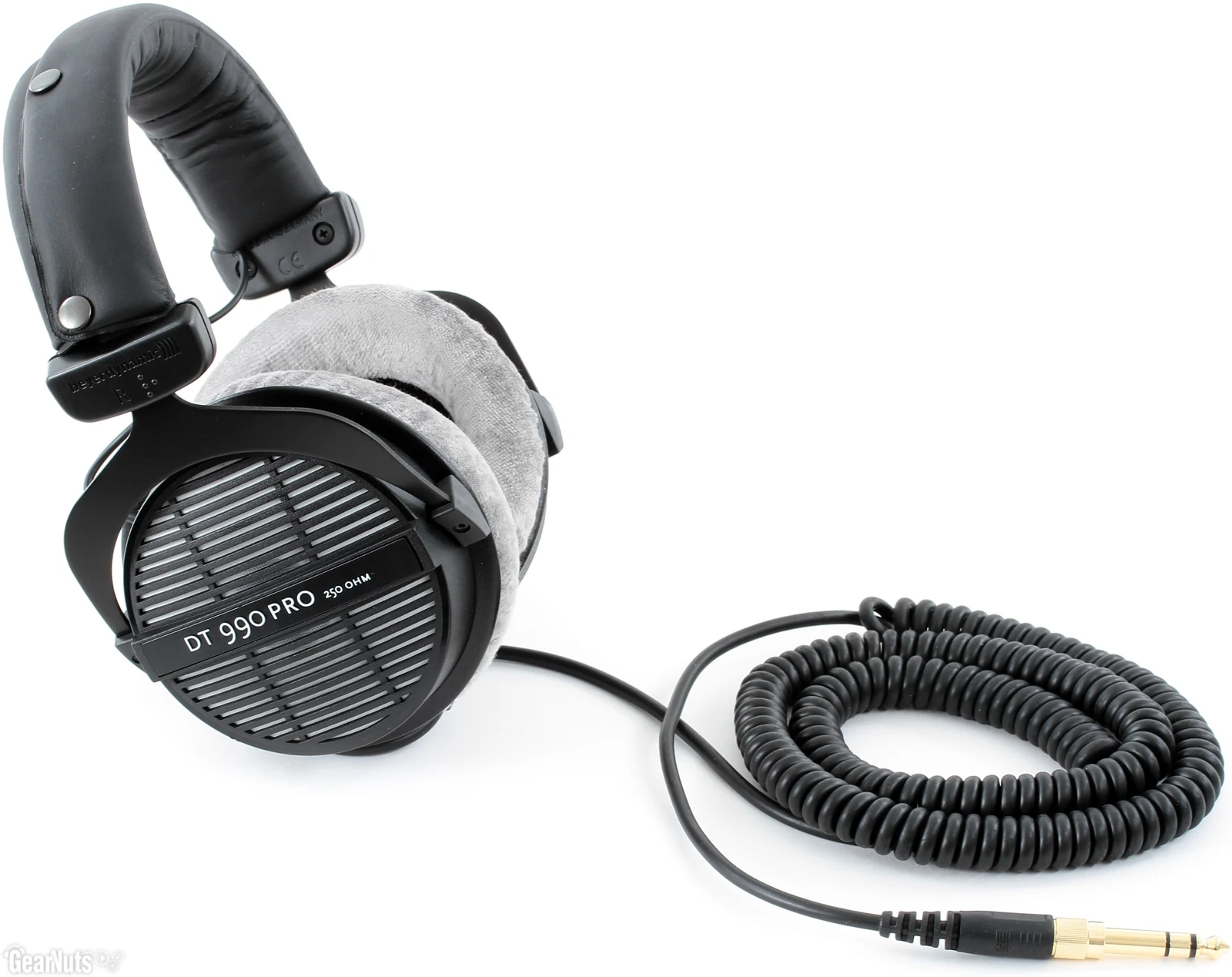 A Beyerdynamic DT 990 PRO headset with a coiled cable, shown from a slightly angled side profile.