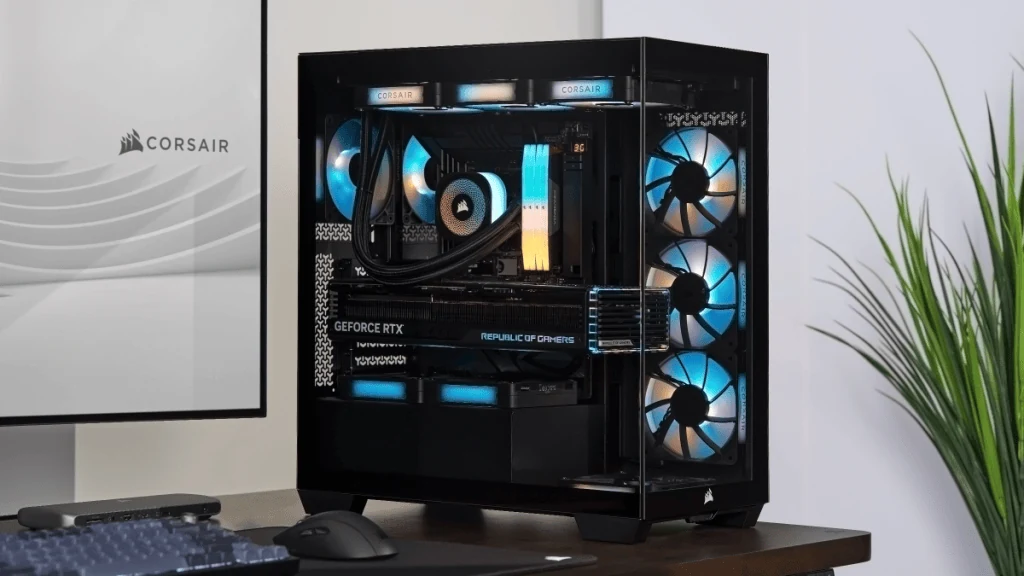 A black Corsair case with blue-lit fans and a visible internal setup, including a GeForce RTX graphics card.
