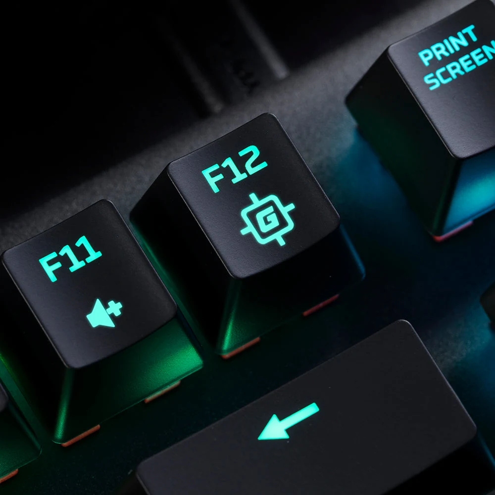 A close-up of a black keyboard with green backlit keys, focusing on the F11 and F12 keys.