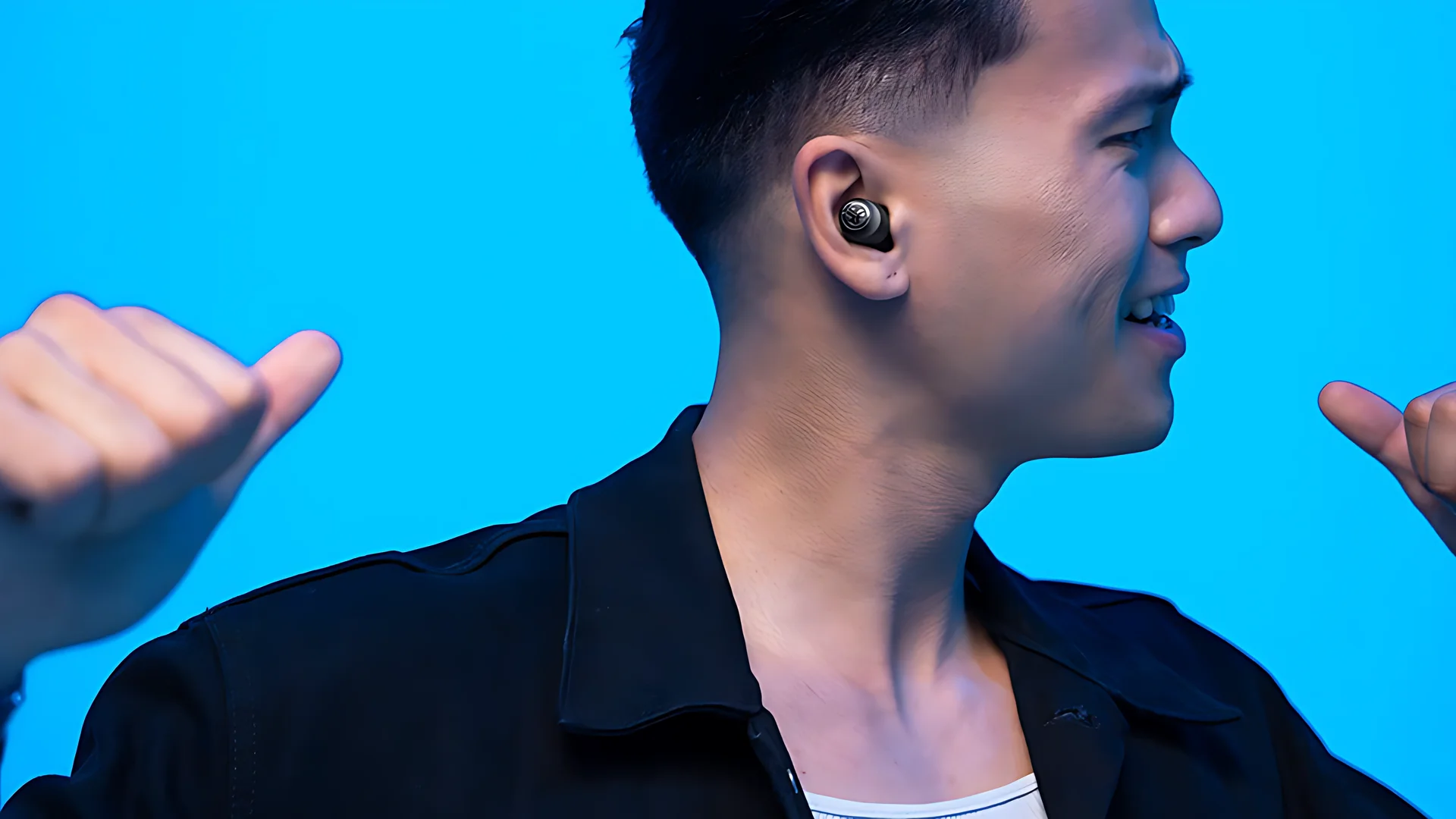 The earbuds are shown in a side profile, with the person wearing them and gesturing towards their ears.