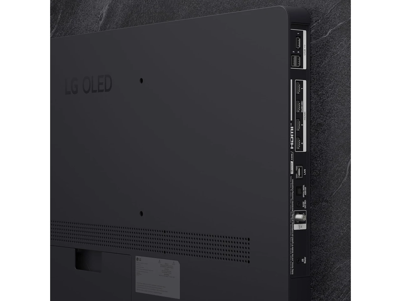 The LG OLED TV is photographed from behind, showing the back panel with ports and a perforated vent.