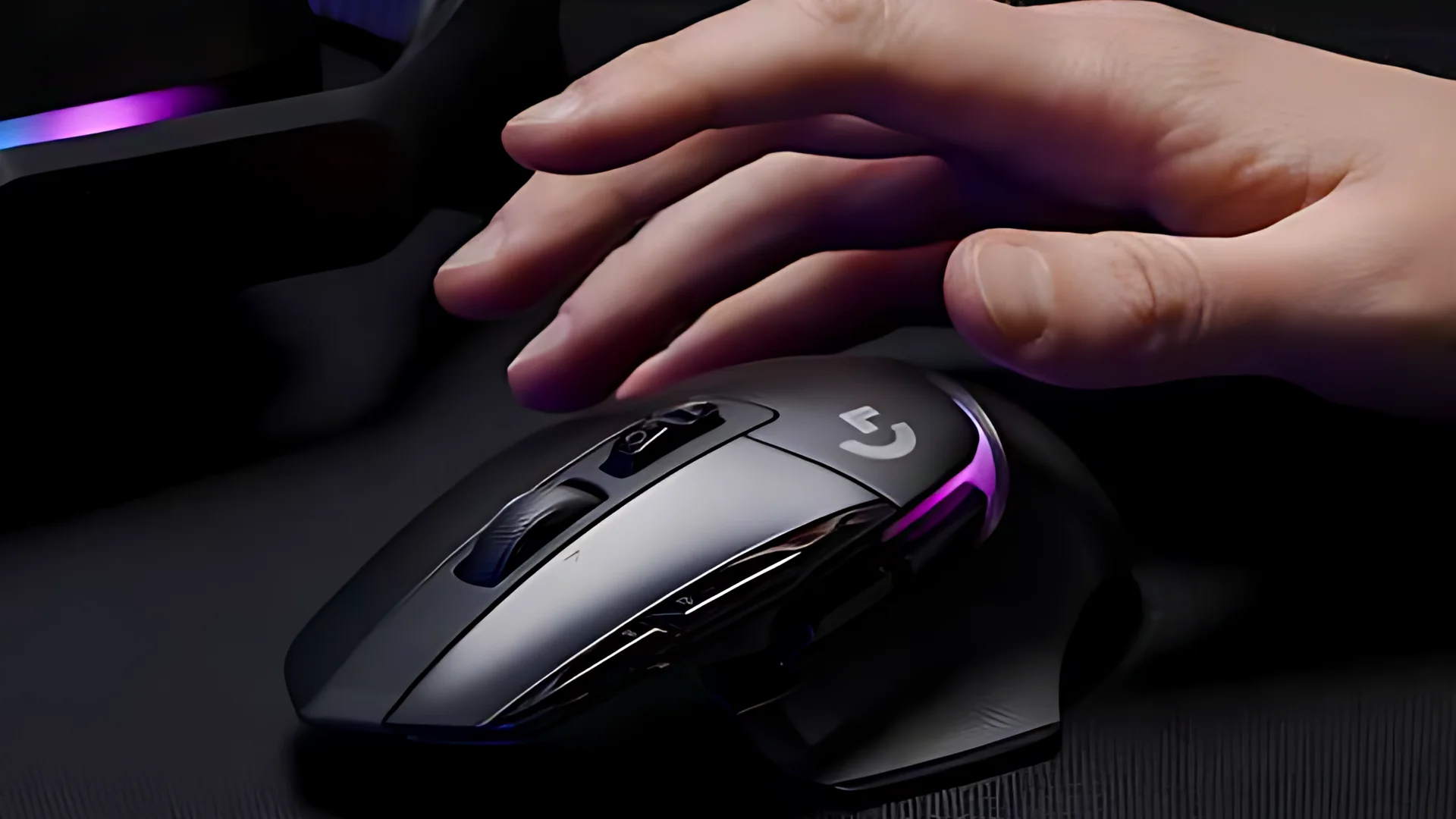The Logitech G502 X Plus is shown in a side profile, with a hand resting on it and a keyboard visible below.