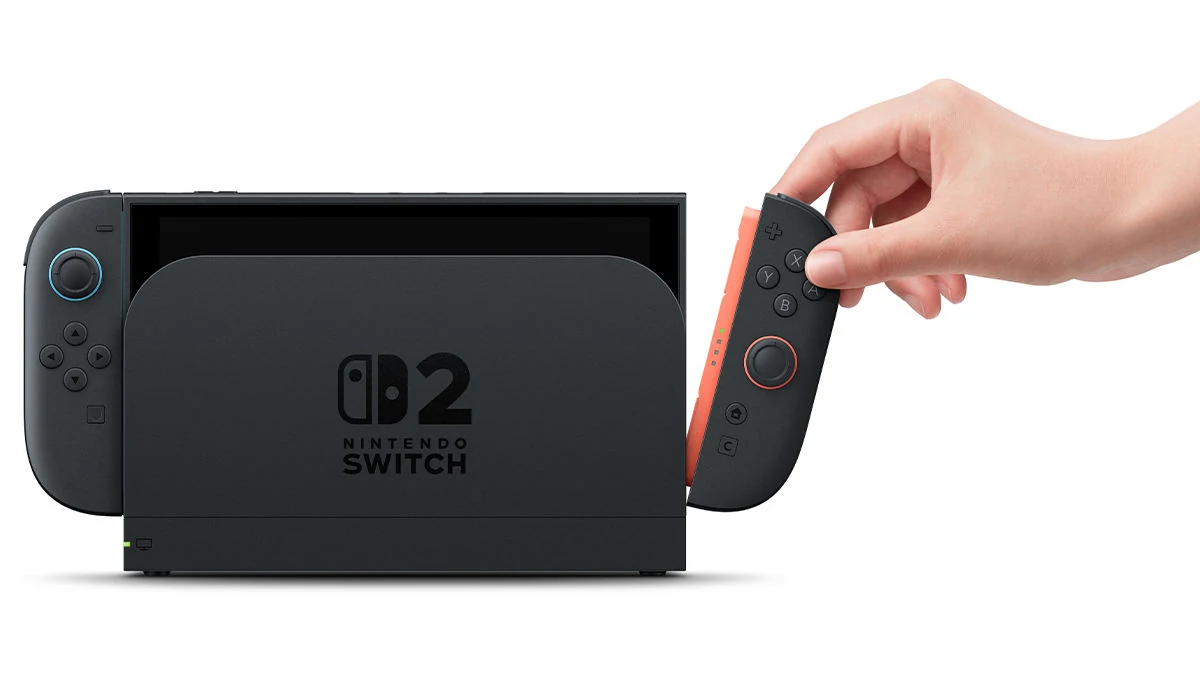 A hand pulling the right Joy-Con 2 off the Nintendo Switch 2 while it sits in the dock