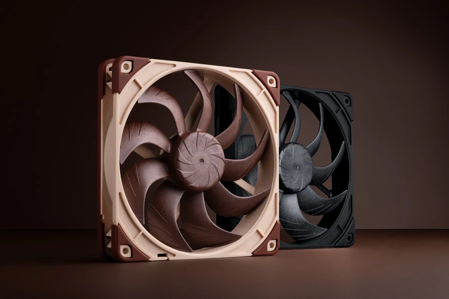 The image shows two Noctua cooling fans, one in a light brown color and the other in black. The fans are positioned side by side against a dark background.