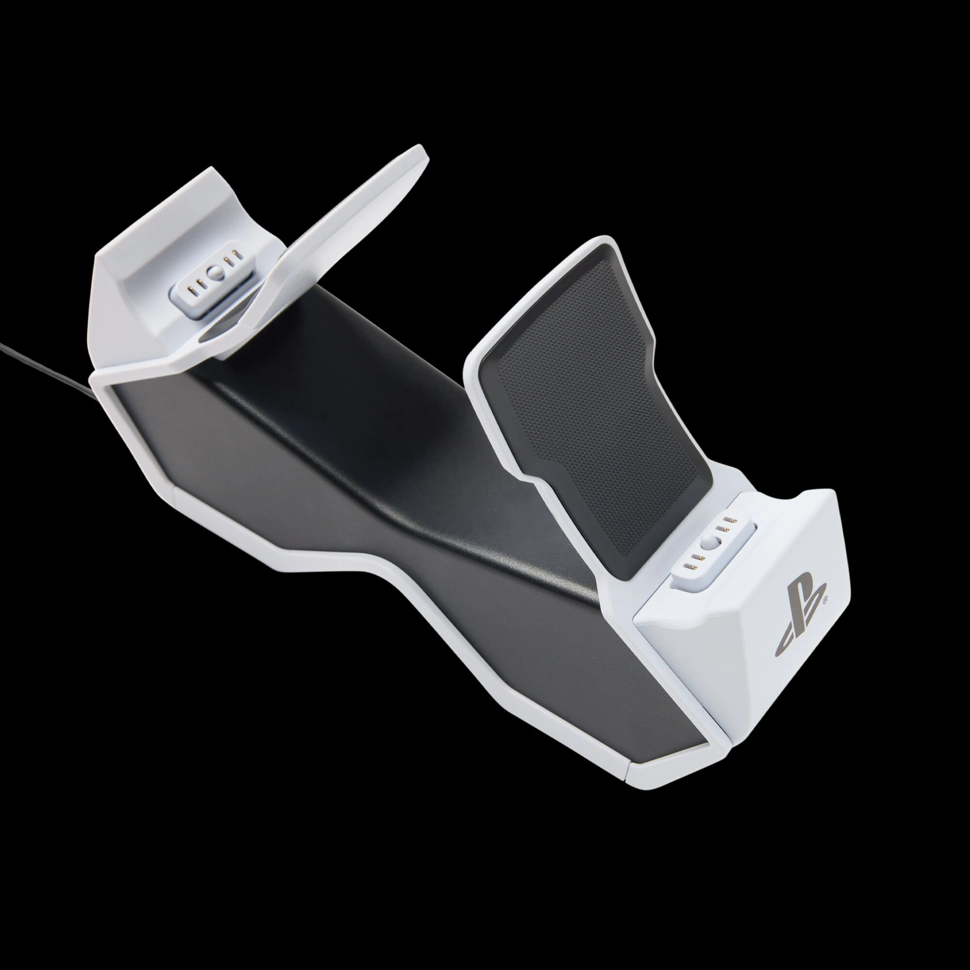 A white and black PlayStation dual charging station with a textured surface, viewed from an angled perspective.