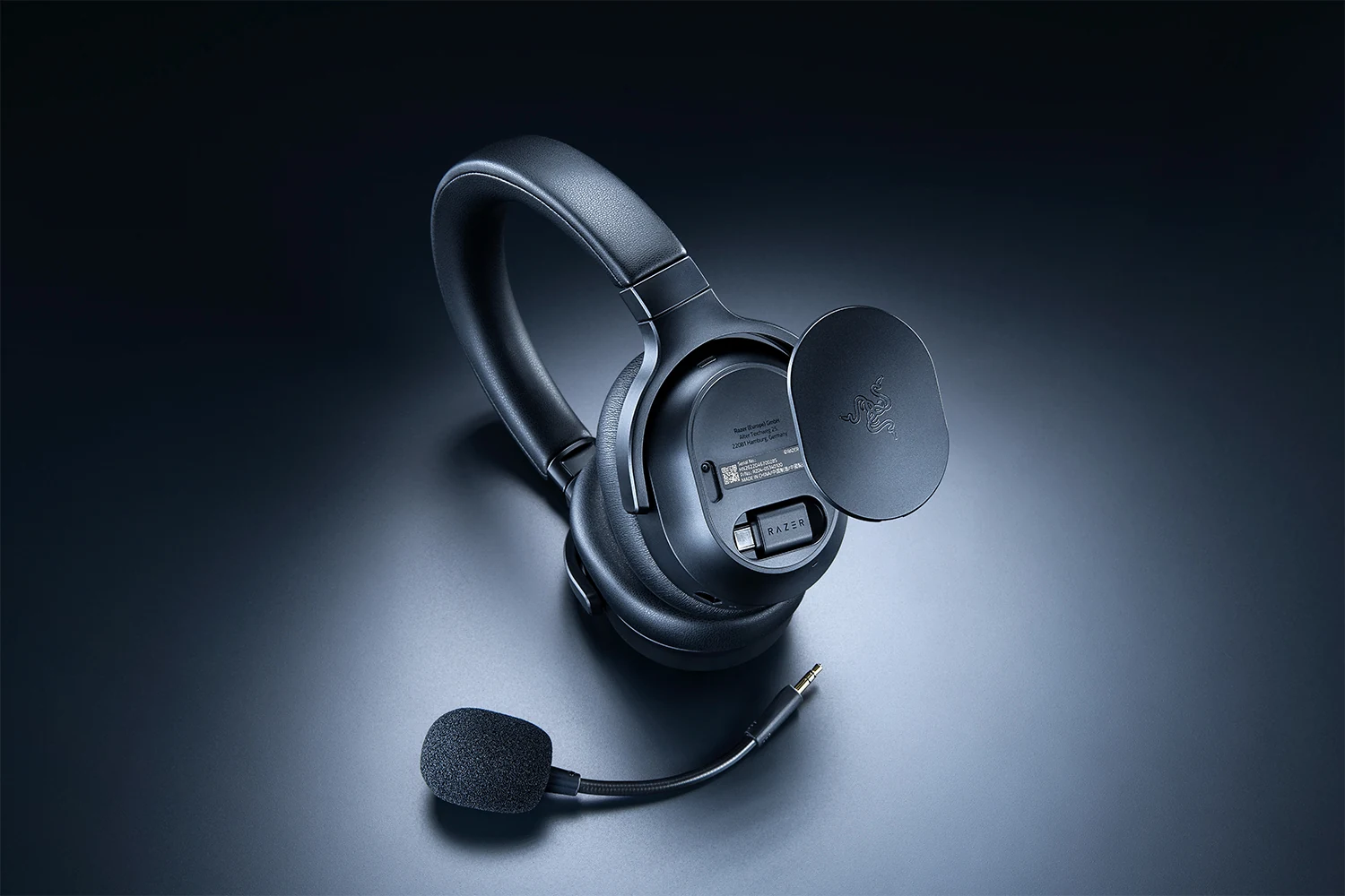A black Razer Barracuda V2 Pro headset is shown from a top-down angle, highlighting its adjustable headband and detachable microphone.