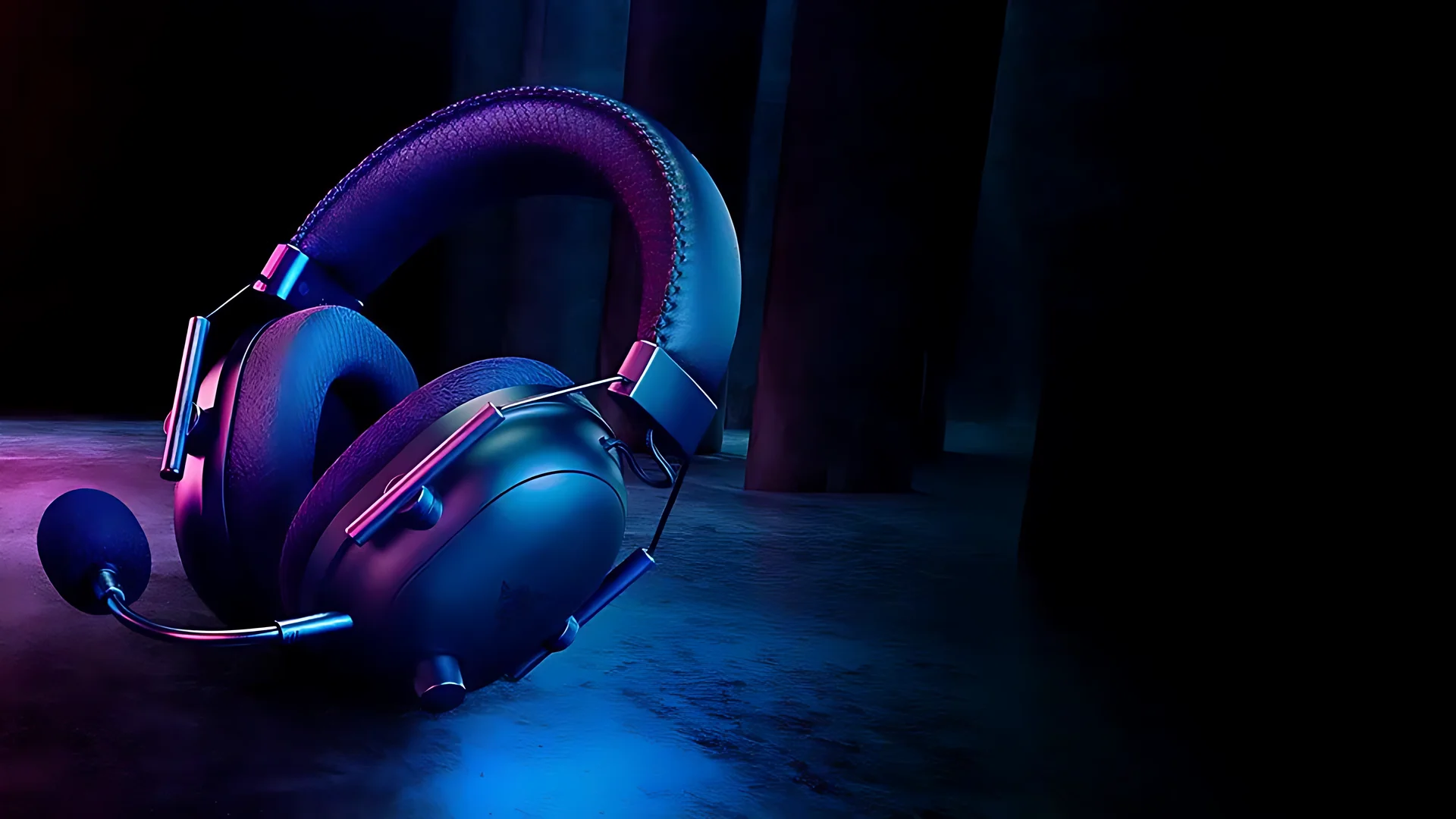 A black Razer BlackShark V2 Pro wireless headset with its detachable microphone, resting on a dark concrete floor lit by blue neon light.