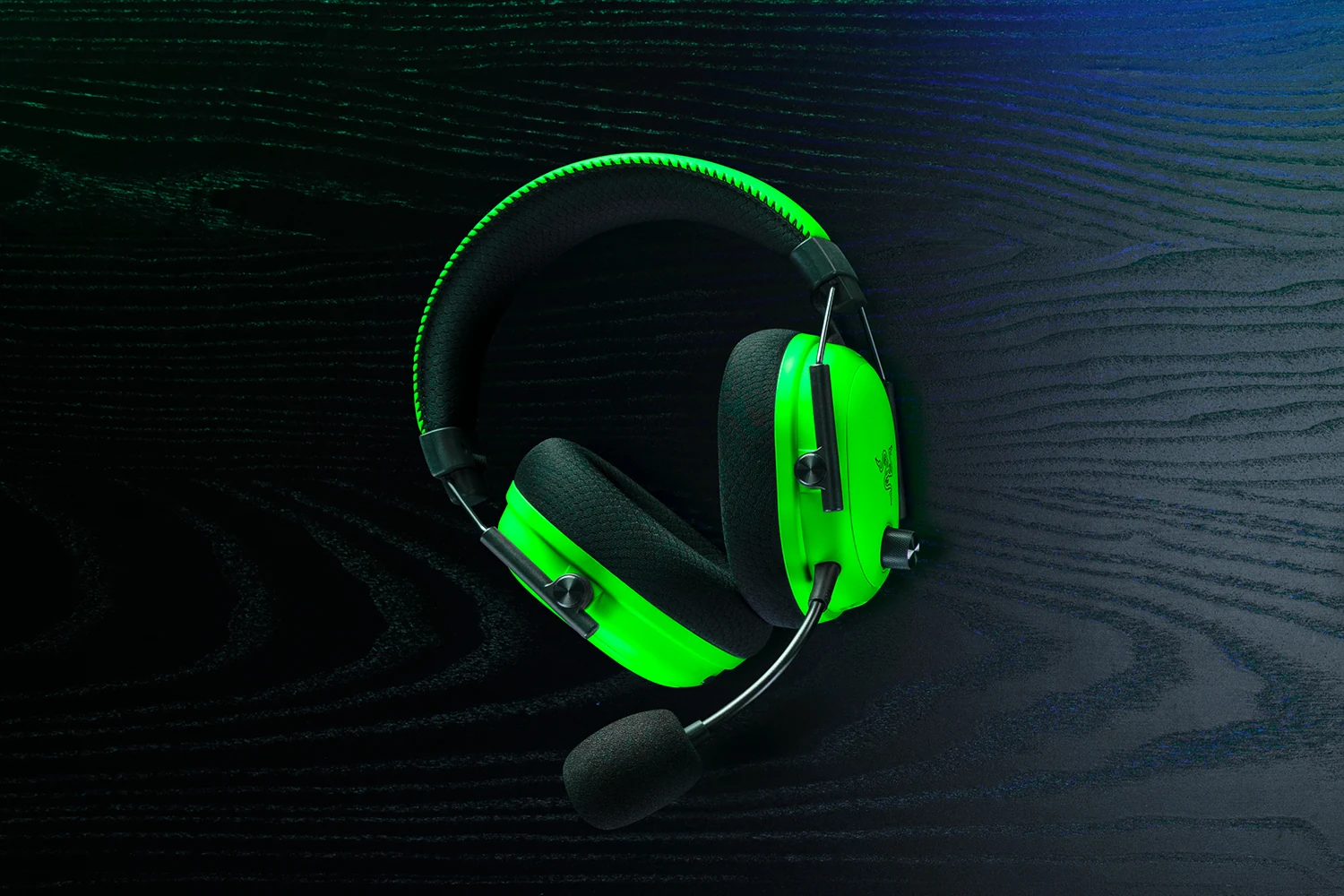 A side profile of a bright green Razer BlackShark V3 Pro Esports Green Edition headset with black ear cushions and a microphone.
