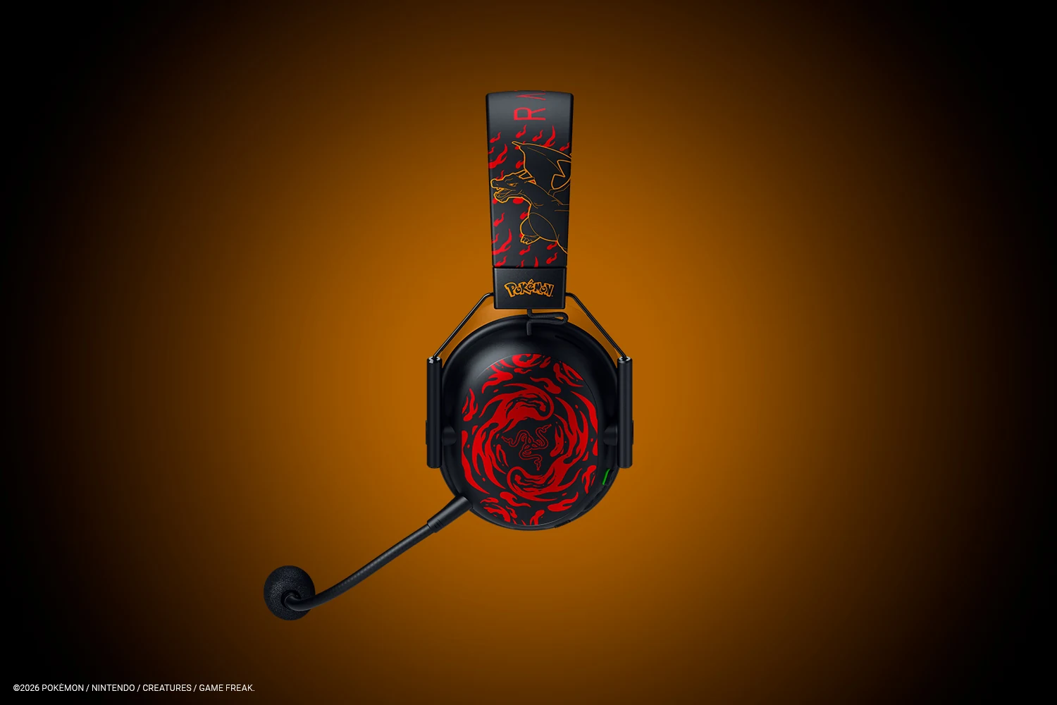 The image shows a black headset with red and yellow dragon-themed graphics on the ear cups, positioned against an orange gradient background.