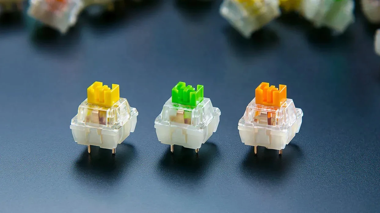 Three Razer mechanical switches - yellow linear, green clicky and orange tactile - the switch options for the BlackWidow V4 Pro.