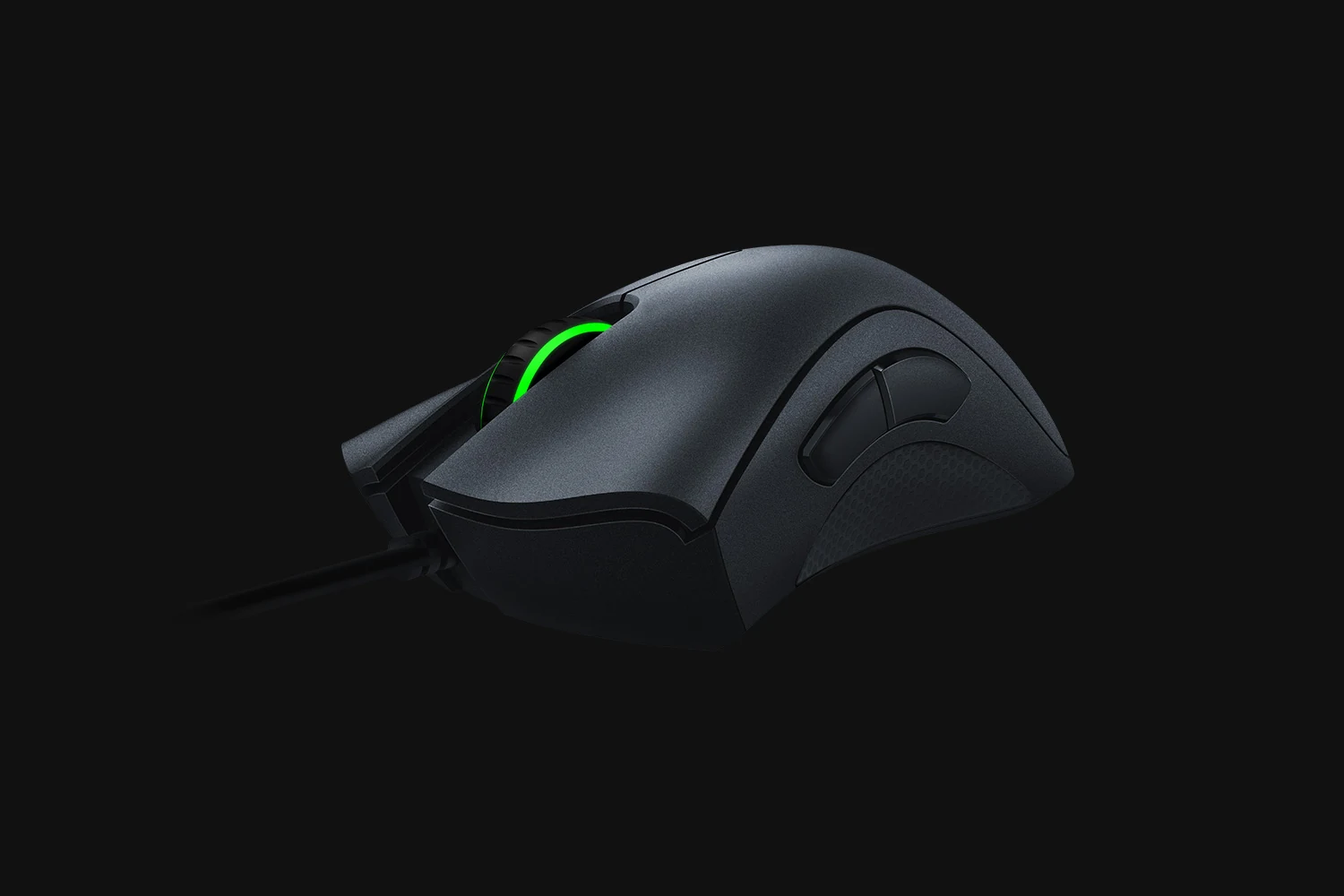A black Razer DeathAdder Essential mouse with a green accent on the scroll wheel, photographed from a three-quarter angle.