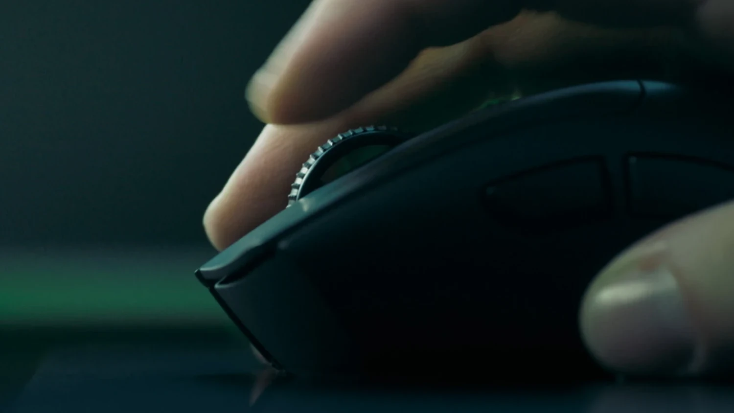 A close-up of a hand holding the Razer DeathAdder V4 Pro mouse, focusing on its side profile and scroll wheel.