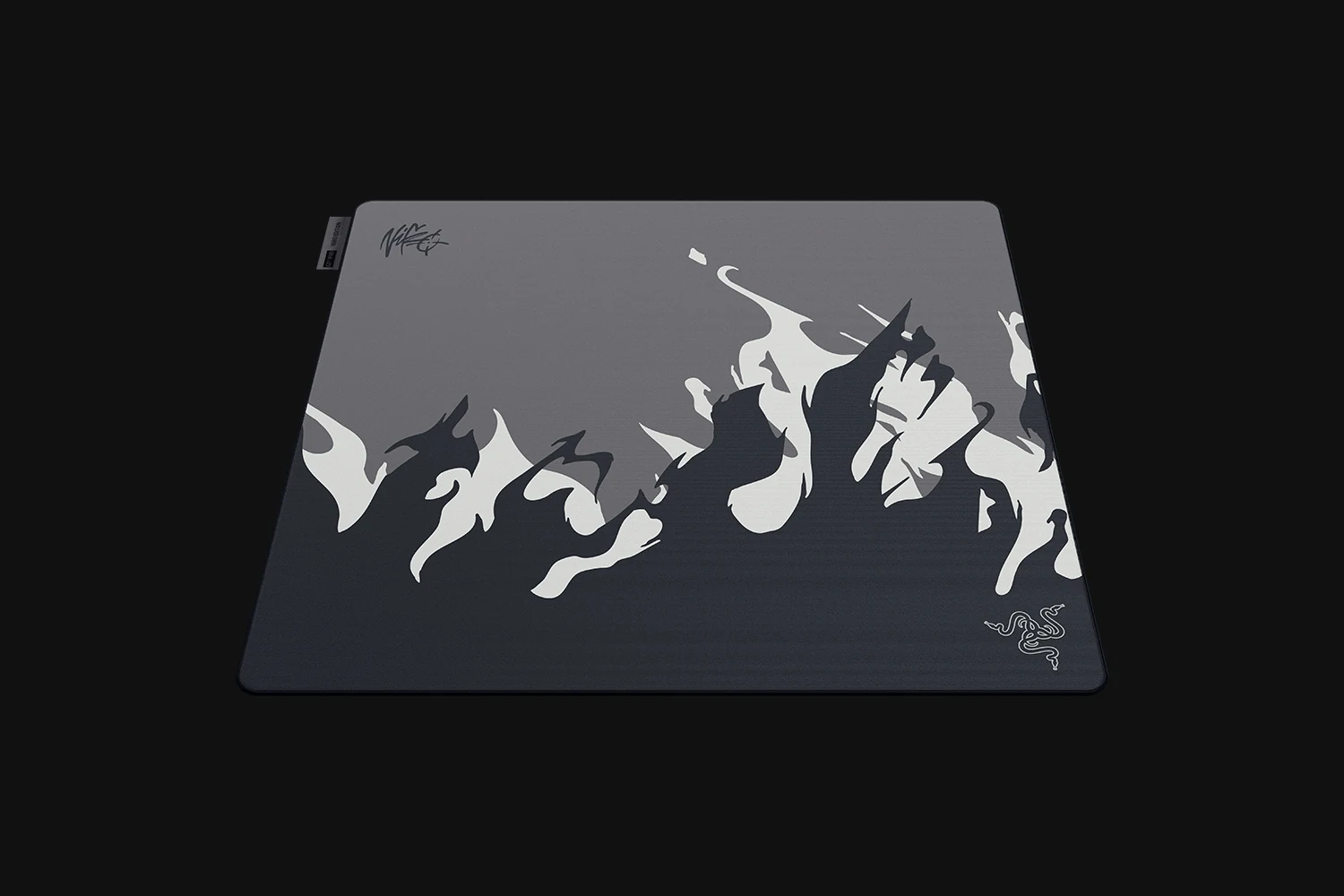 A top-down view of a mousepad with a dark gray surface and white dragon silhouettes, featuring the Razer logo in the bottom right corner.
