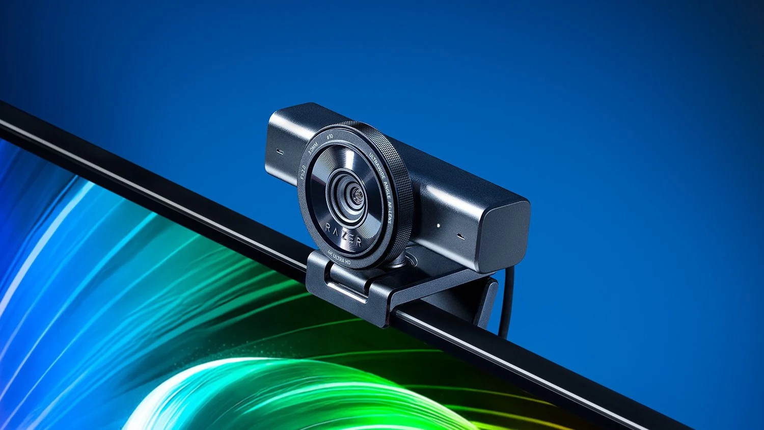 A Razer Kiyo V2 webcam mounted on a monitor, shown in a three-quarter angle with its lens and branding clearly visible.