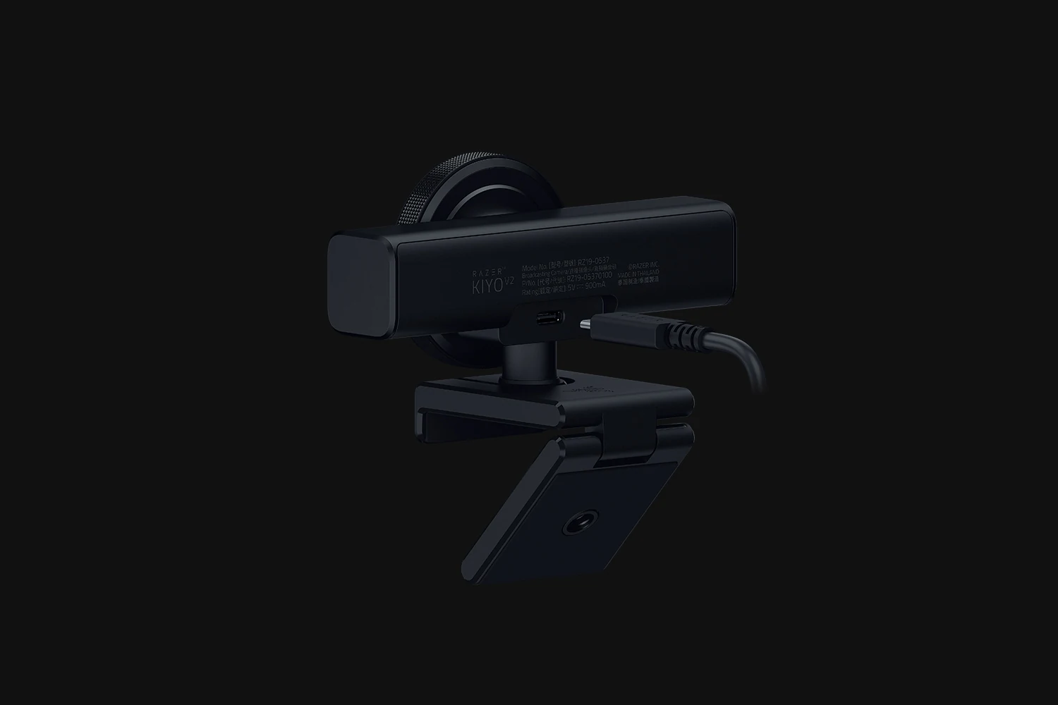 The Razer Kiyo V2 webcam is shown in a side profile with its cable attached, against a dark background.