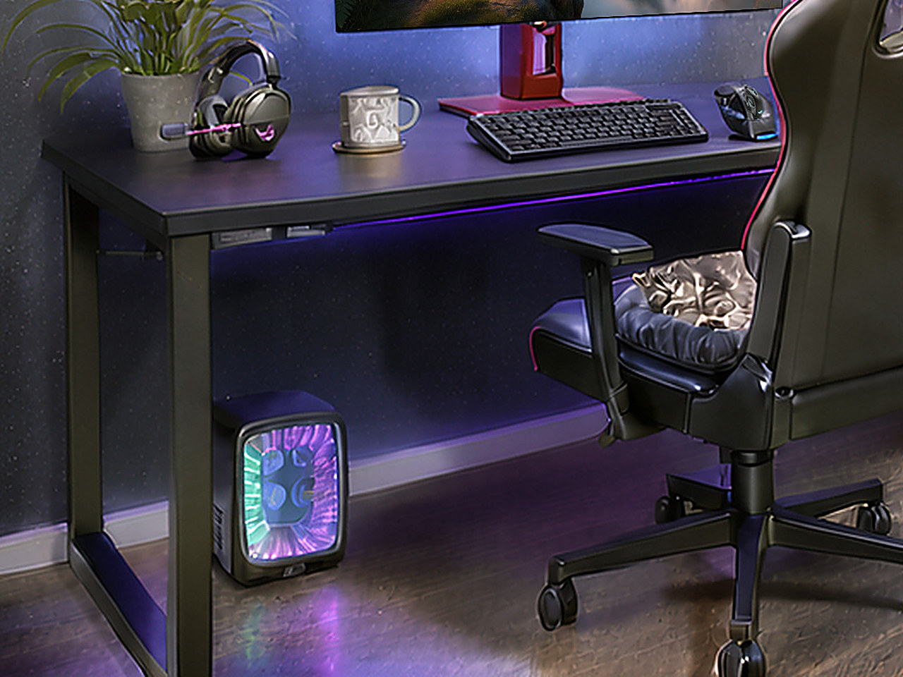 Close-up of the black desk surface with a central monitor stand and red base detail