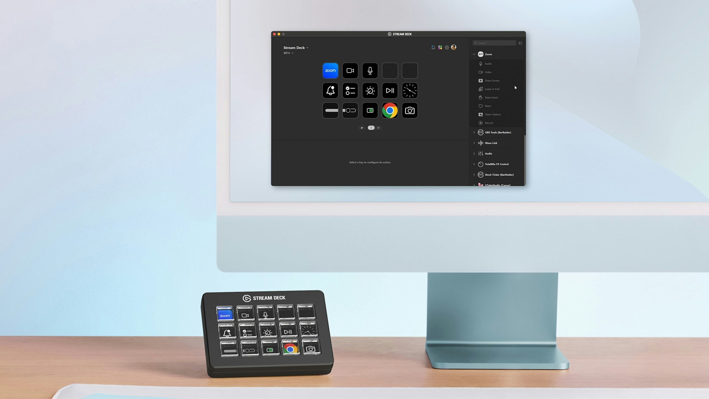 A black Stream Deck device with a grid of buttons is shown on a desk next to an iMac.