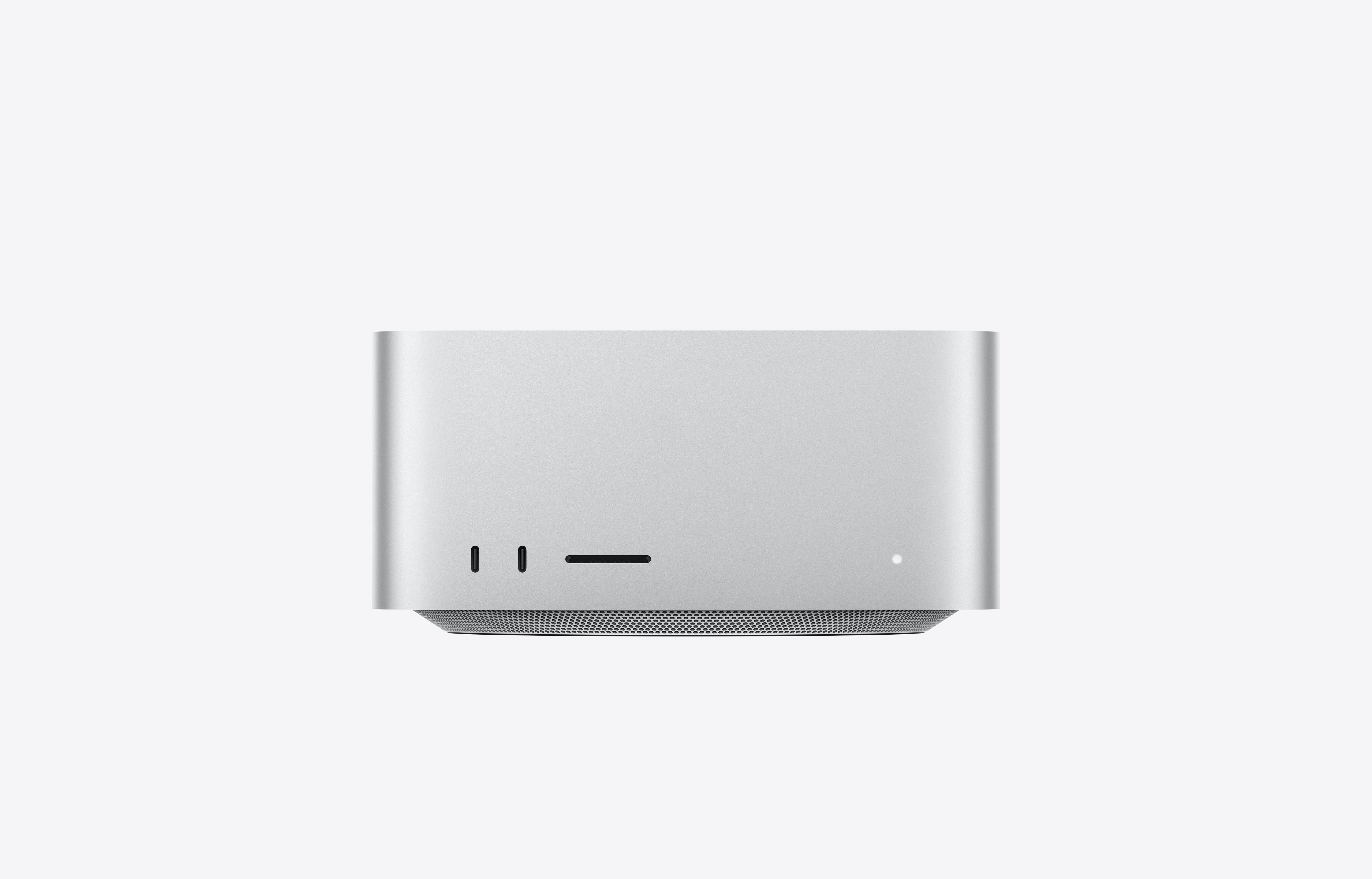 A silver Mac Studio desktop computer photographed from the front, with two USB-C ports, an SD card slot and a power light.