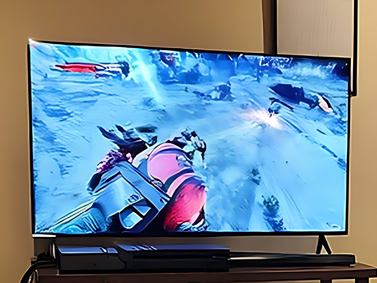 Samsung 65-Inch Class S90H Series in the warm cozy gaming room scene