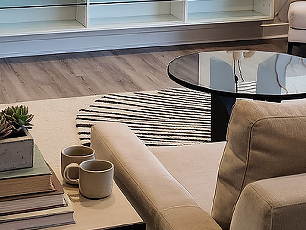 Close-up of the beige rectangular area rug with black and cream zebra-inspired lines.