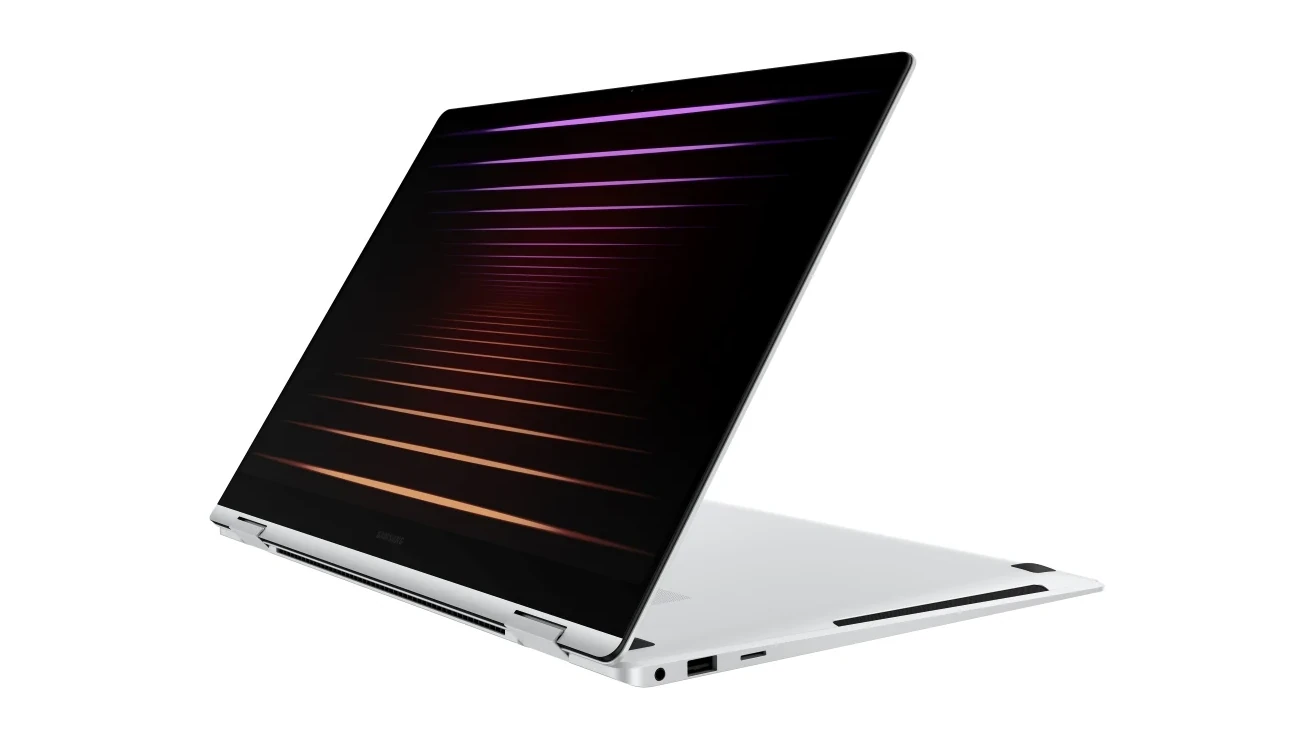 A white Samsung Galaxy Book5 Pro 360 Copilot+ PC photographed from a three-quarter angle, showcasing its back panel and part of the screen with a gradient design.