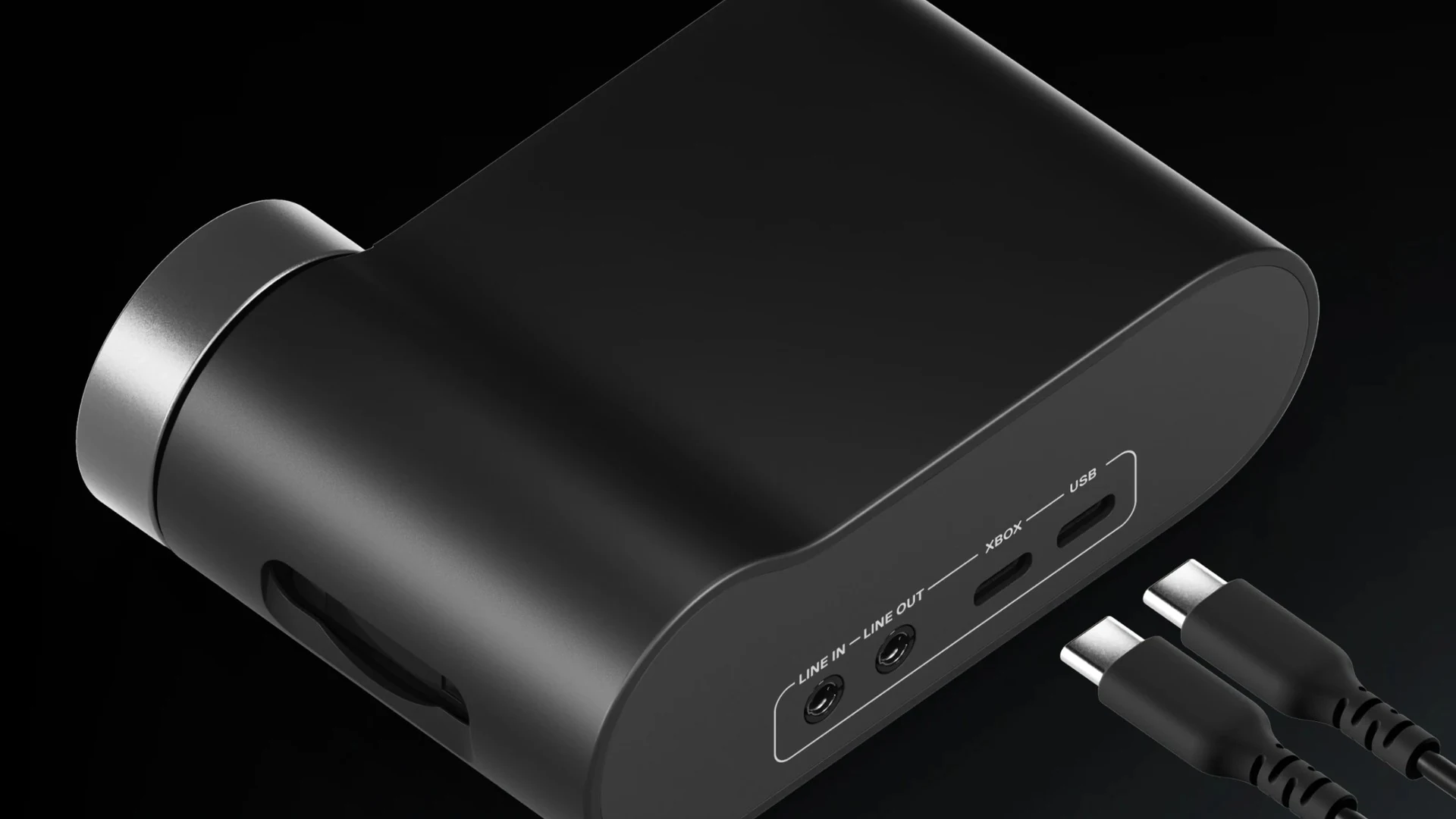 A black, cylindrical device with a USB port and two audio jacks visible from the side.