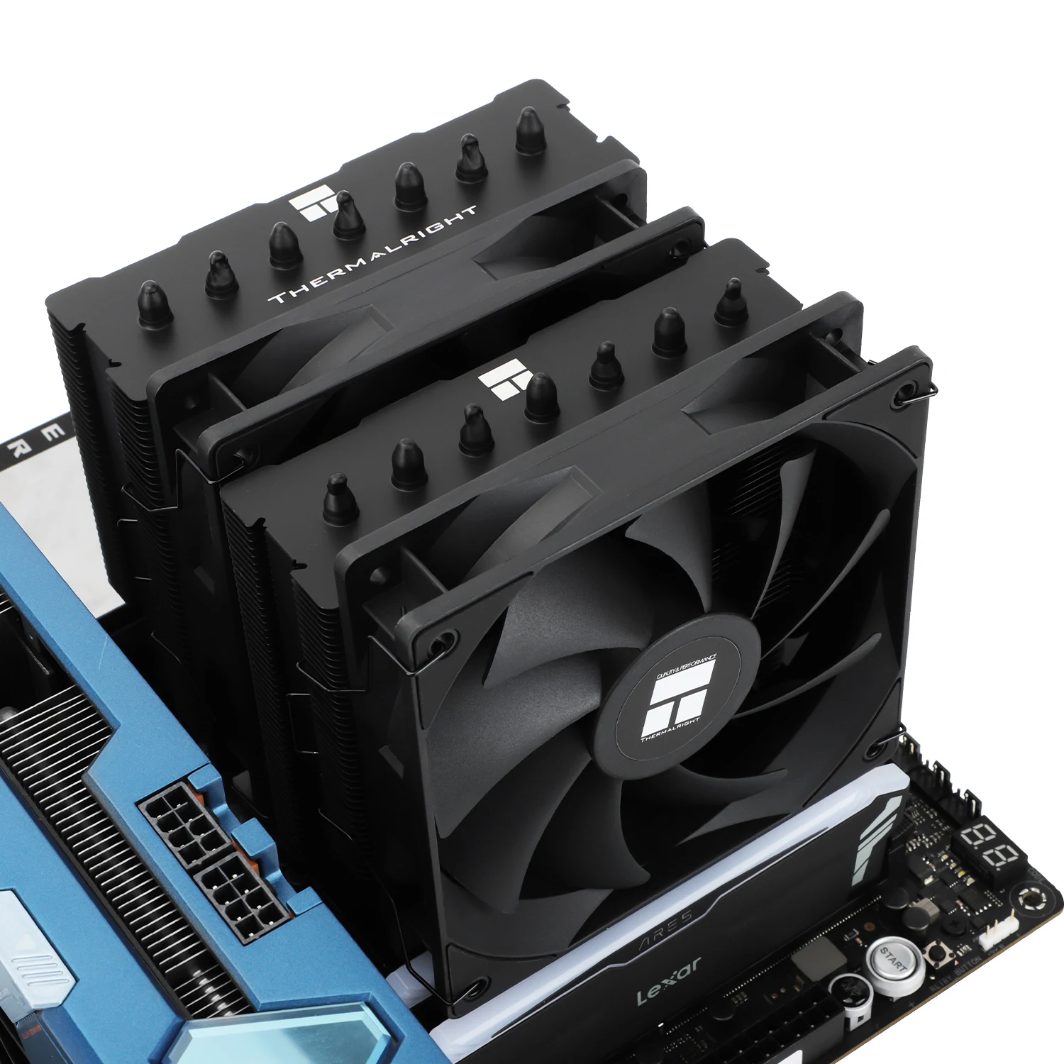 A top-down view of a black CPU cooler with multiple fins and a fan, mounted on a motherboard.
